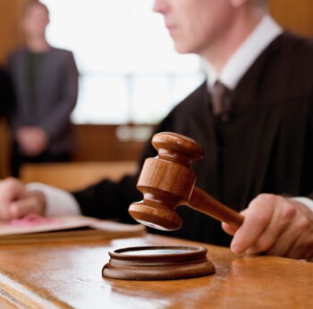 Judge holding gavel in courtroom