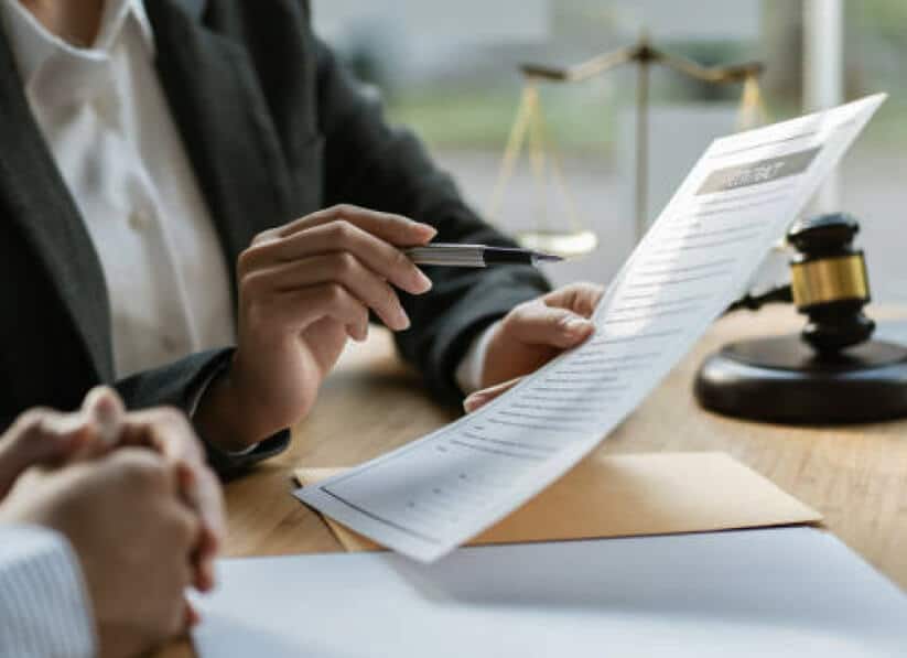 Image of two people (from neck down) reviewing a contract.