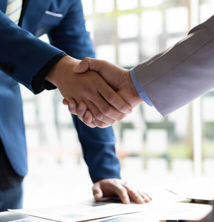 A close of of two men shaking hands